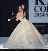 DJ SODA kisses in a hostess-style princess dress.